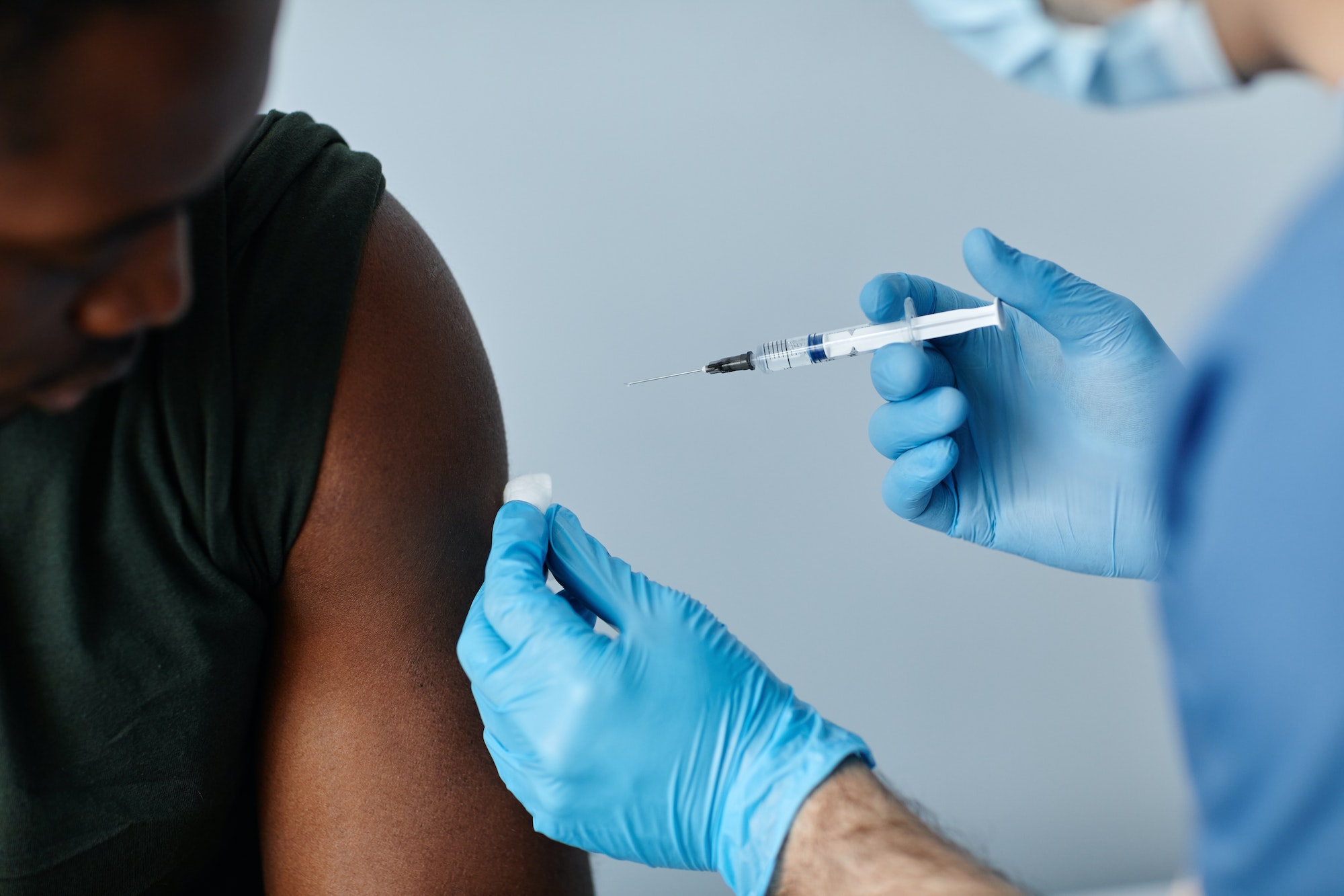 Patient receiving a vaccine injection in the shoulder