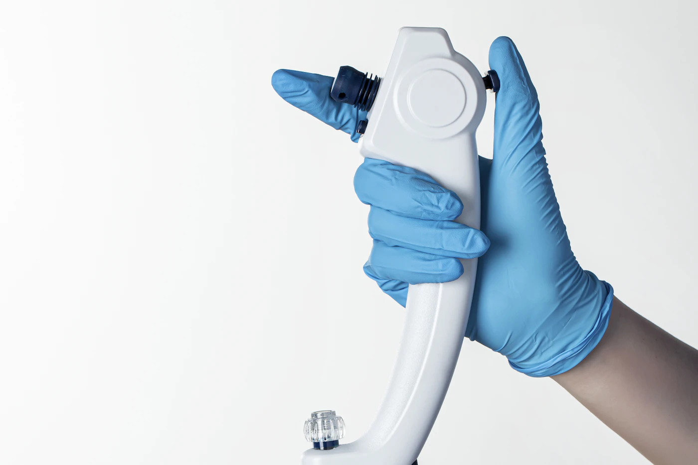 Gloved hand holding the control unit of a flexible endoscope