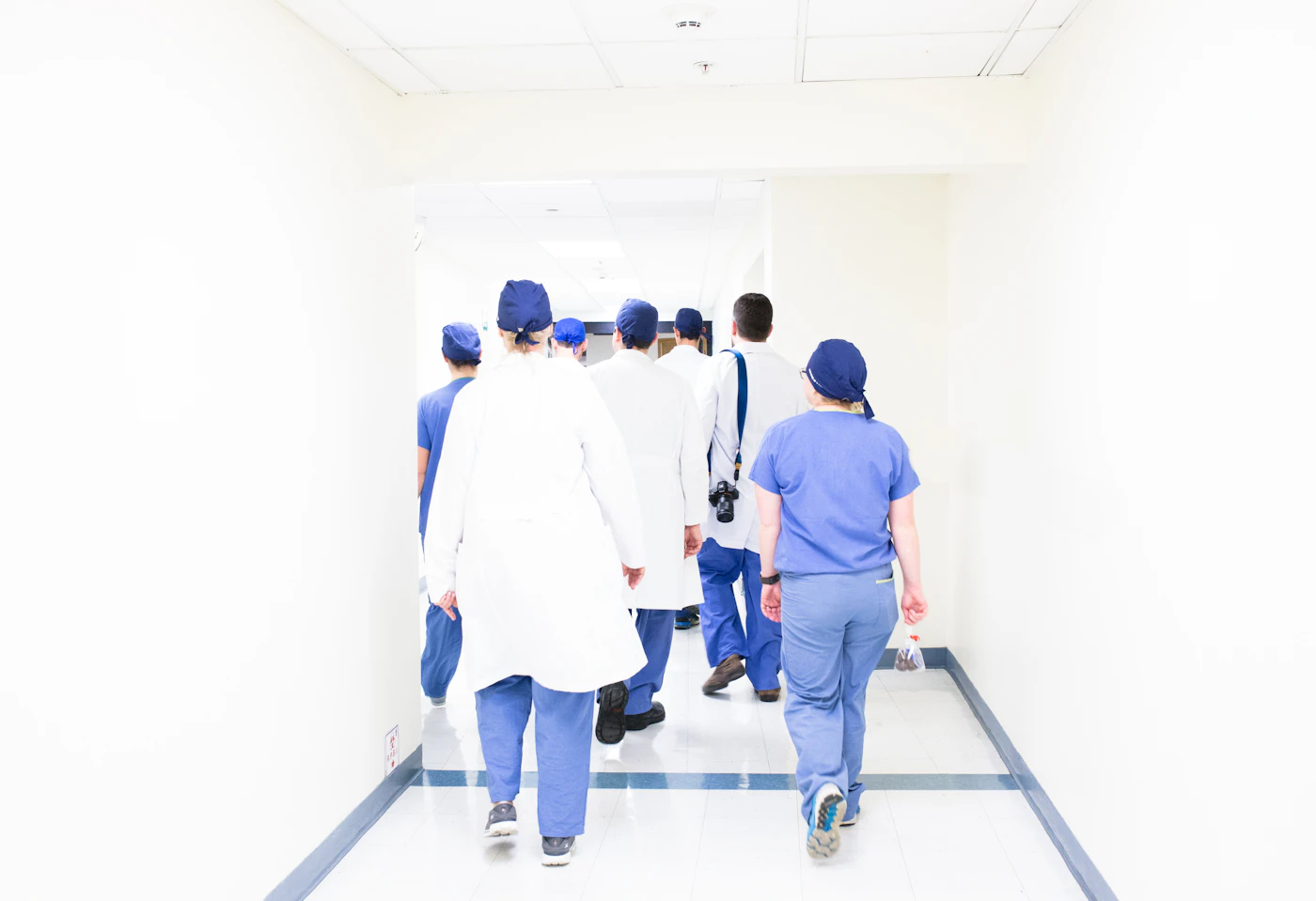 Doctors and nurses walking down a hospital corridor