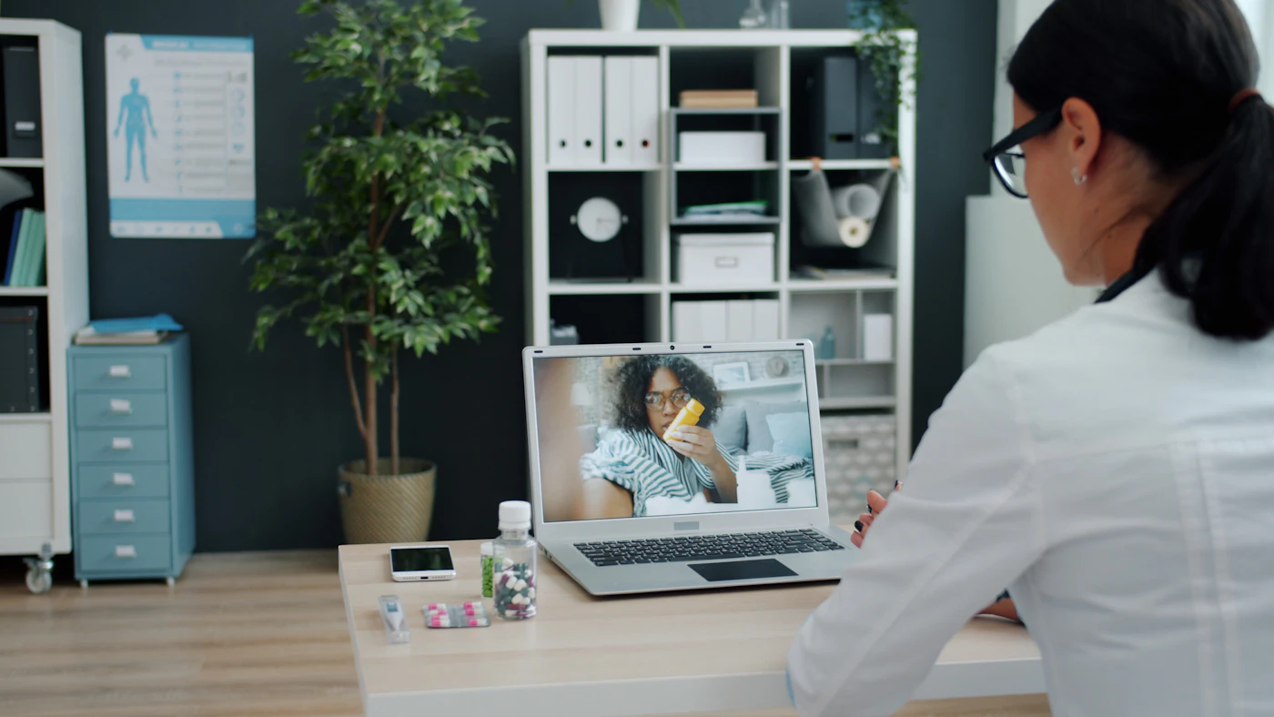 Clinician meeting a patient by video call on a laptop