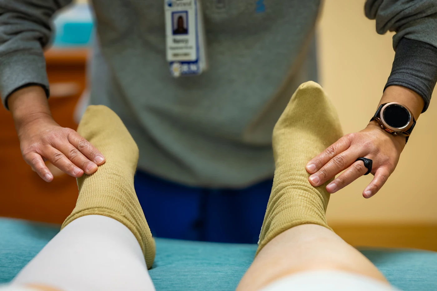 Nurse examining a patient's feet during a foot check