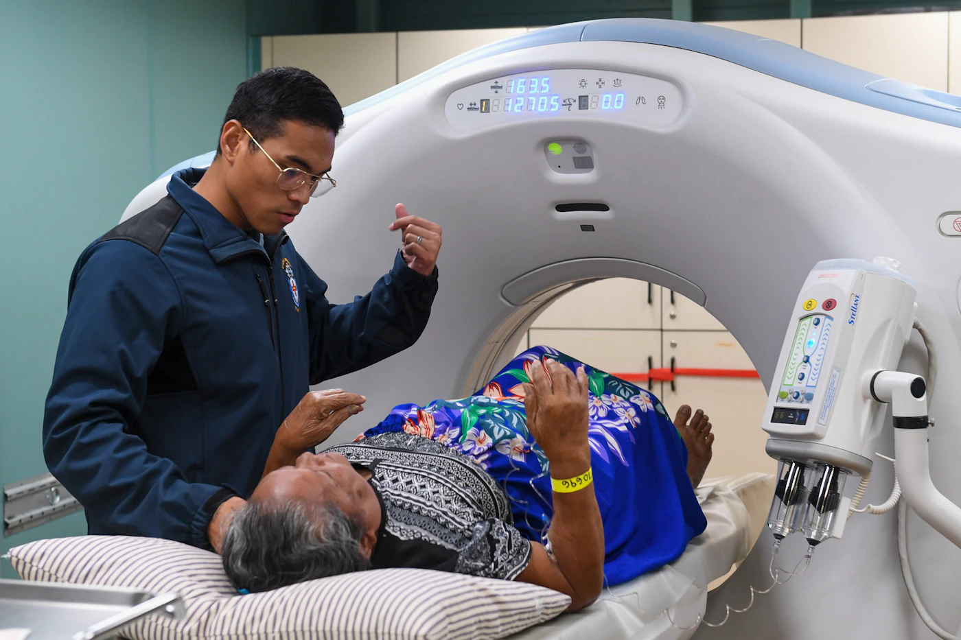 Technologist positioning a patient on a CT scanner table