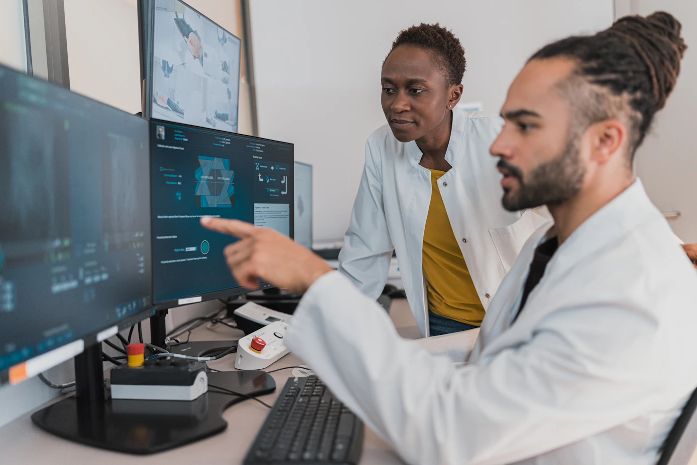 Two radiologists reviewing images on computer monitors