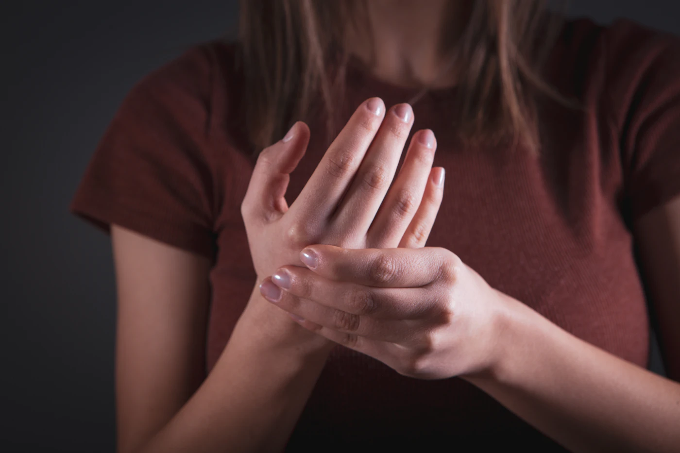 Woman holding her painful hand and wrist