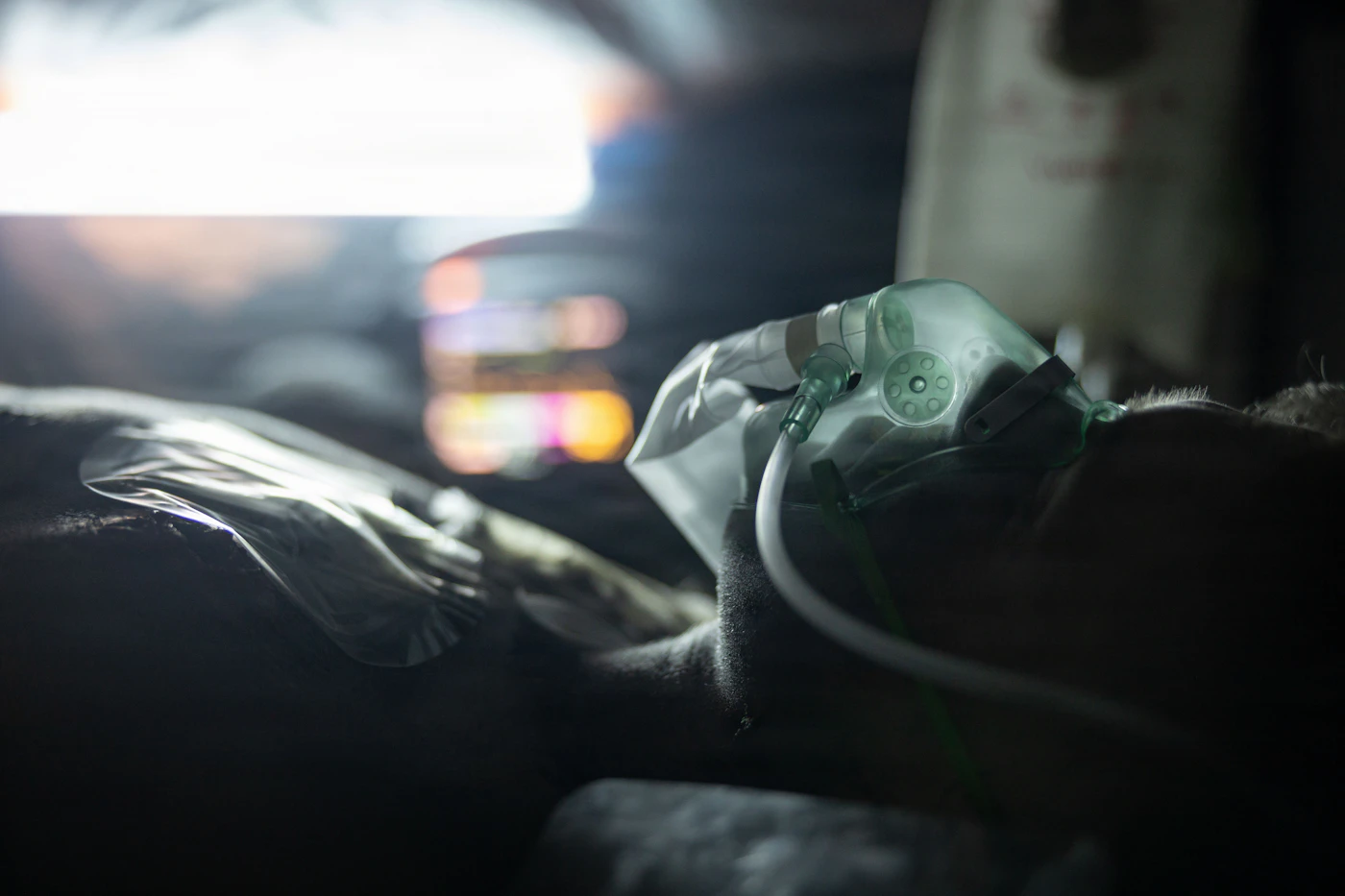 Patient sleeping in a dim room wearing a breathing mask